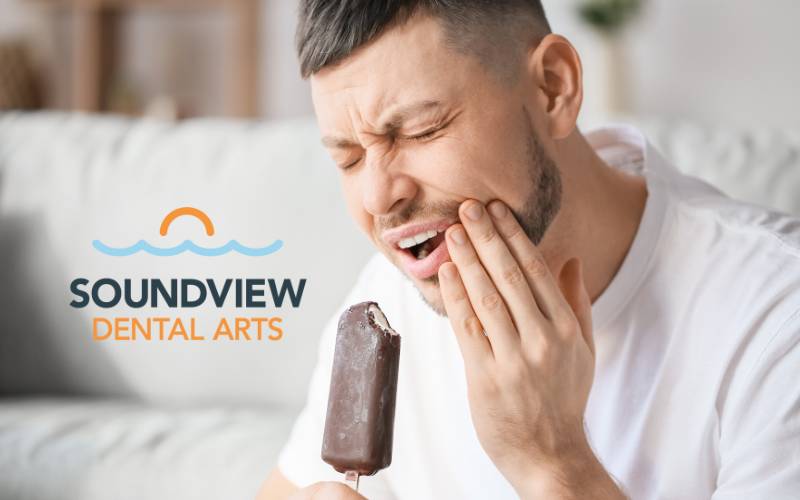 Man experiencing pain from cavity while eating ice cream